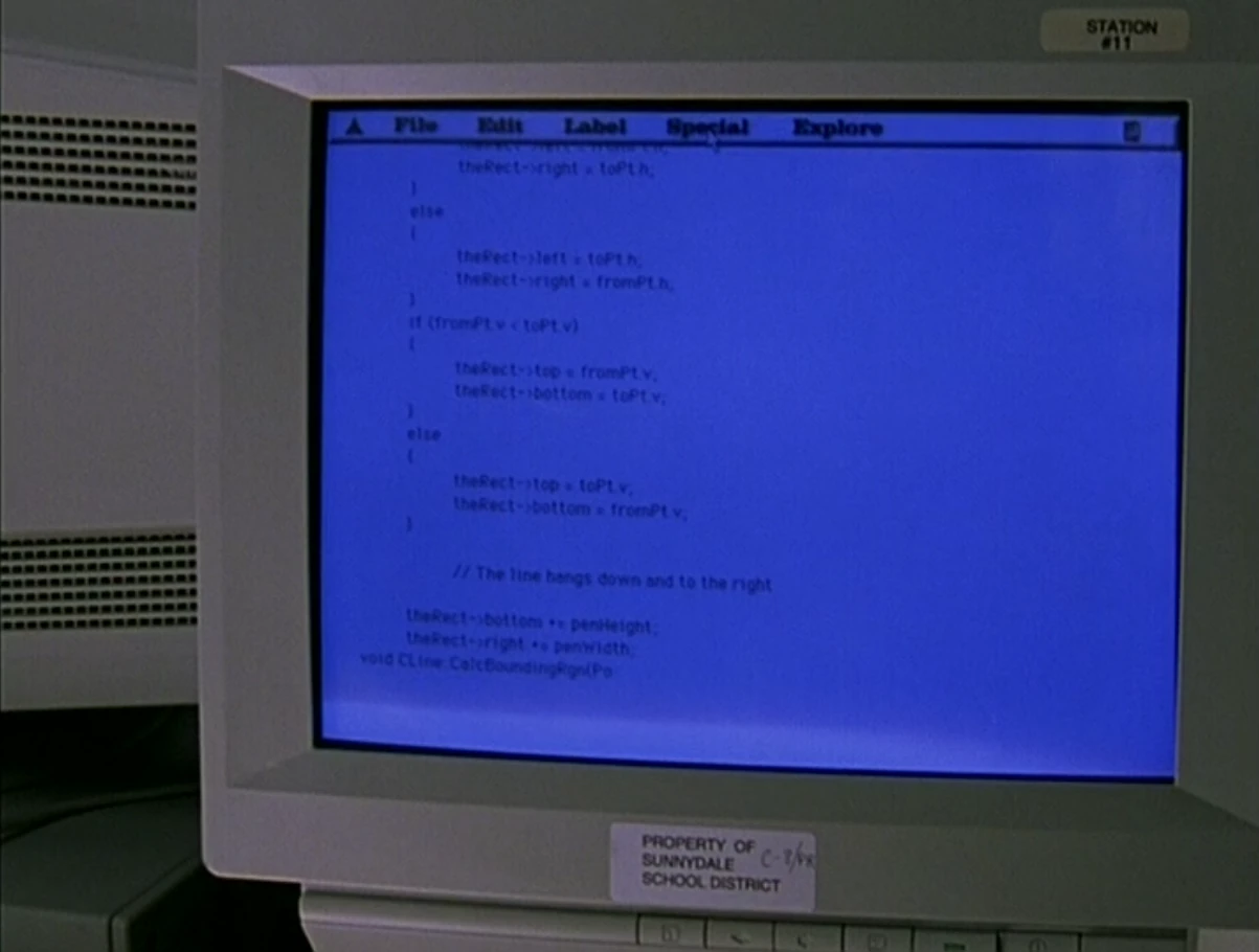 A CRT monitor with computer code on the screen