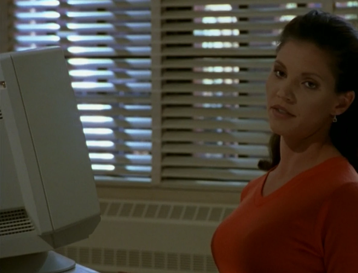 Cordelia (Charisma Carpenter) sitting at a computer monitor